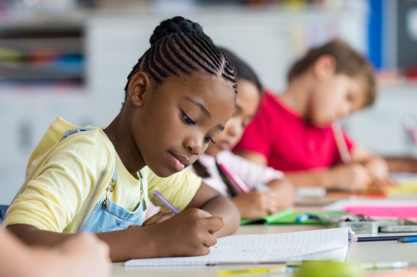 A student writing in her exercise book