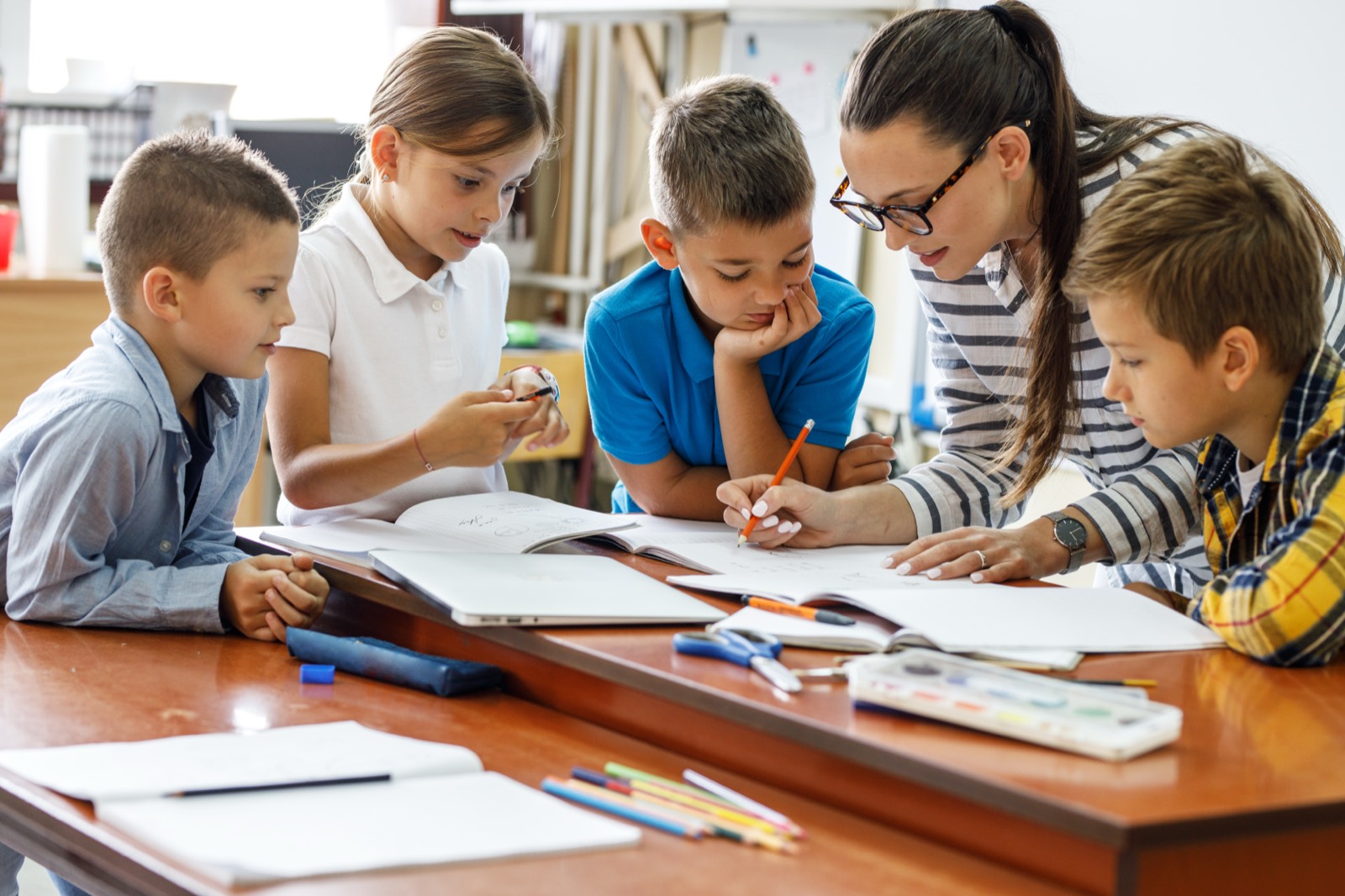 A tutor working through a lesson with students